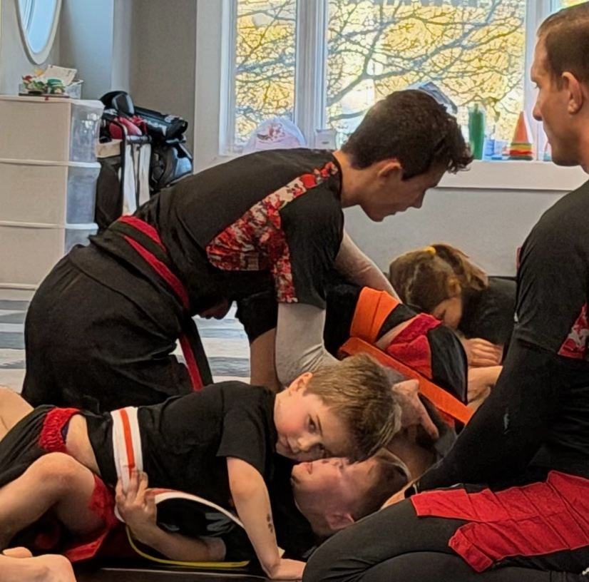 Kids practicing grappling drills in class