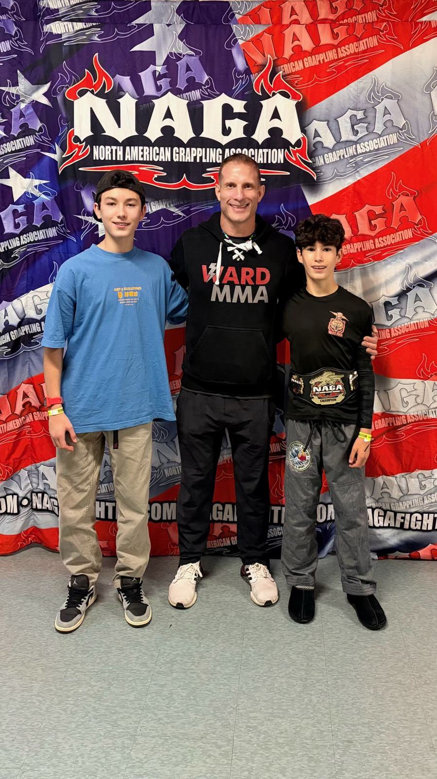 Coach Jay with two students at a NAGA tournament